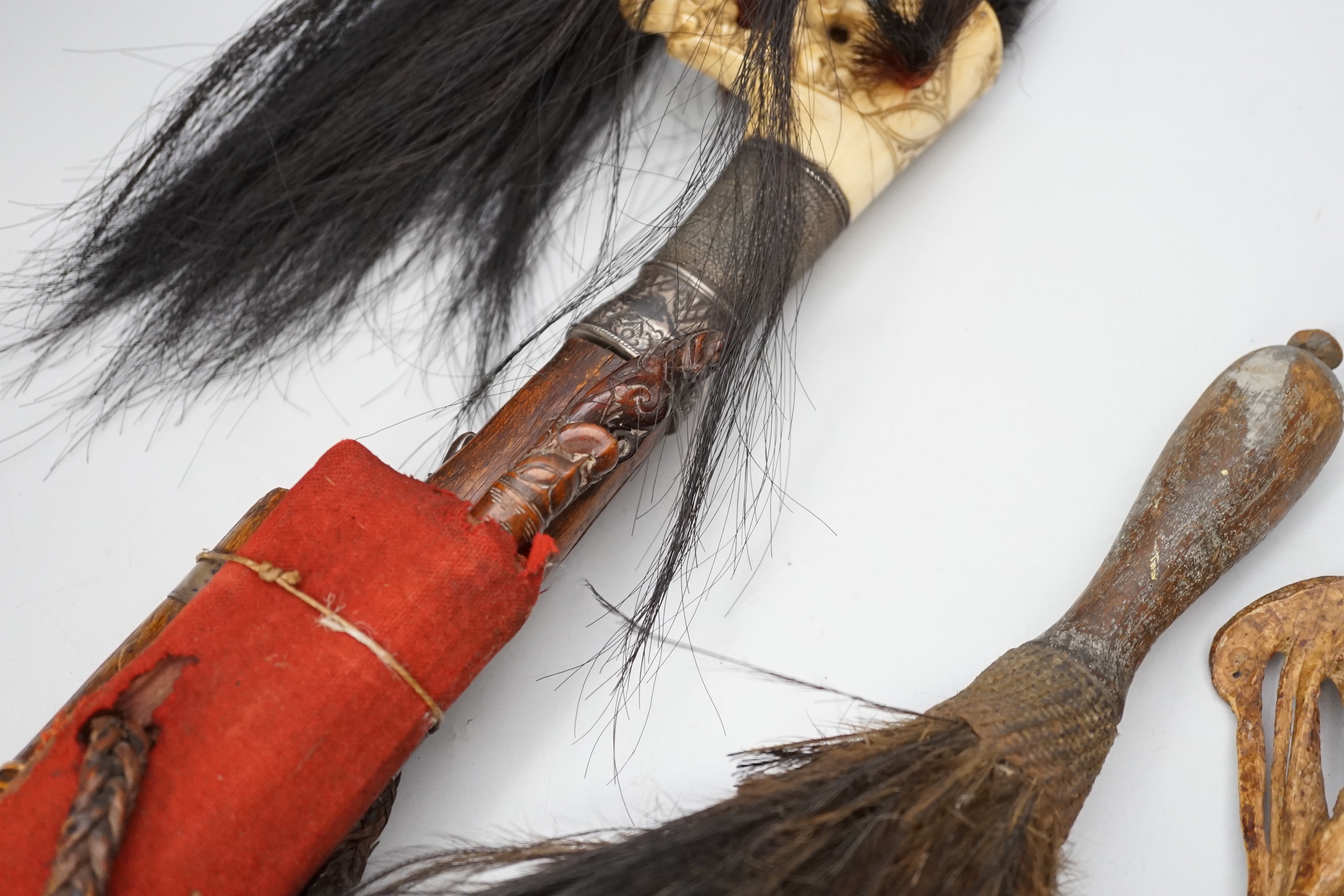 A Borneo 'headhunter's sword', a bone carving and feather swot (3), sword 77 cm long